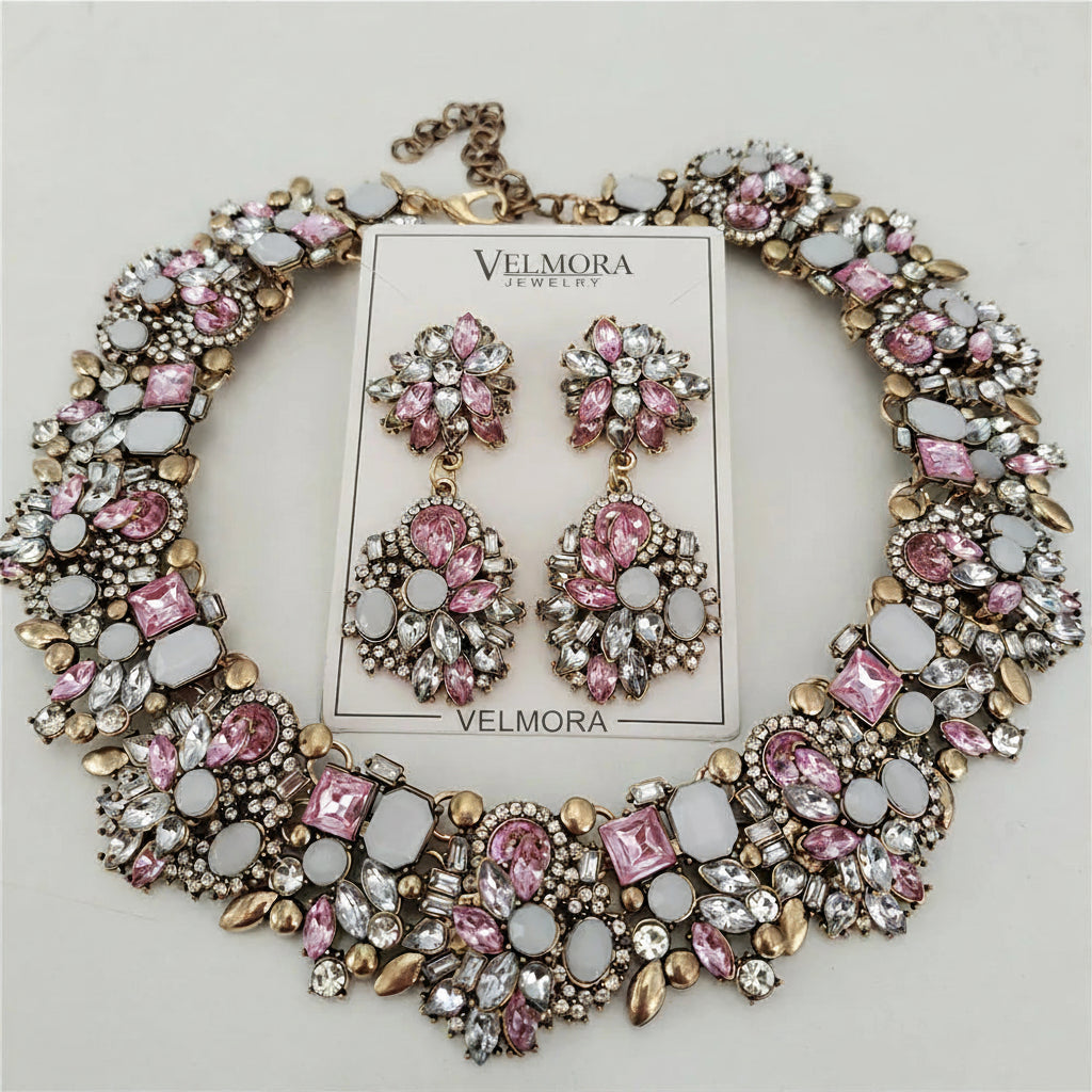 Jewelry set with pink and gold accents on a white background