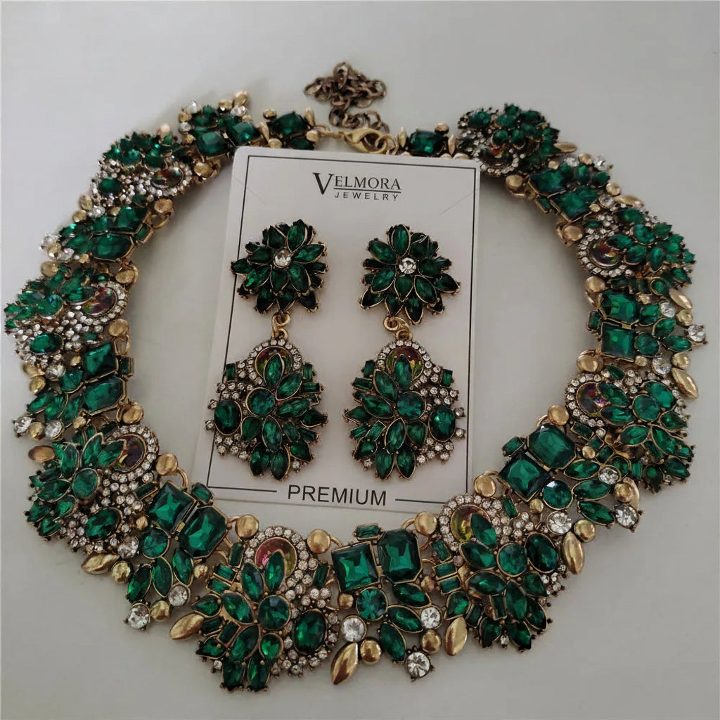 Green and gold jewelry set with necklace and earrings on a white background