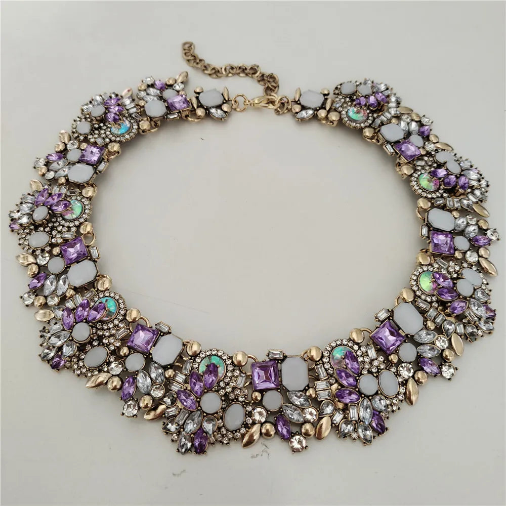 Decorative necklace with purple and gold accents on a light gray background
