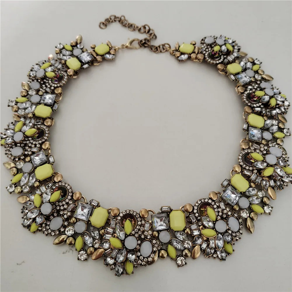 Necklace with yellow and clear gemstones on a light gray background