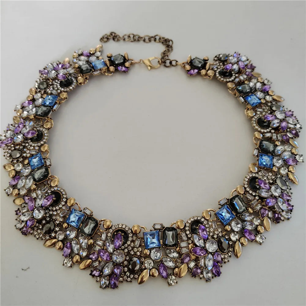 Necklace with multicolored gemstones on a light gray background