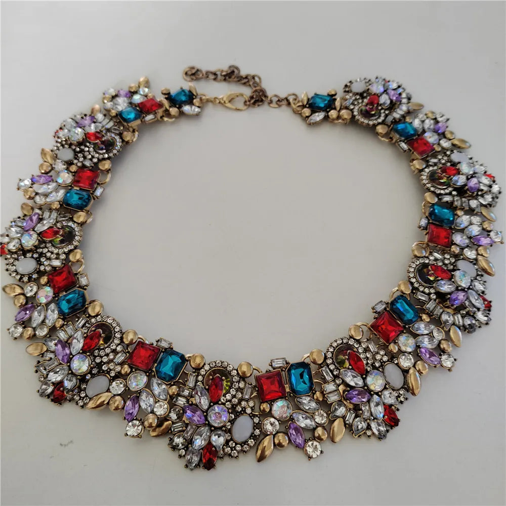 Colorful jeweled necklace on a light gray background