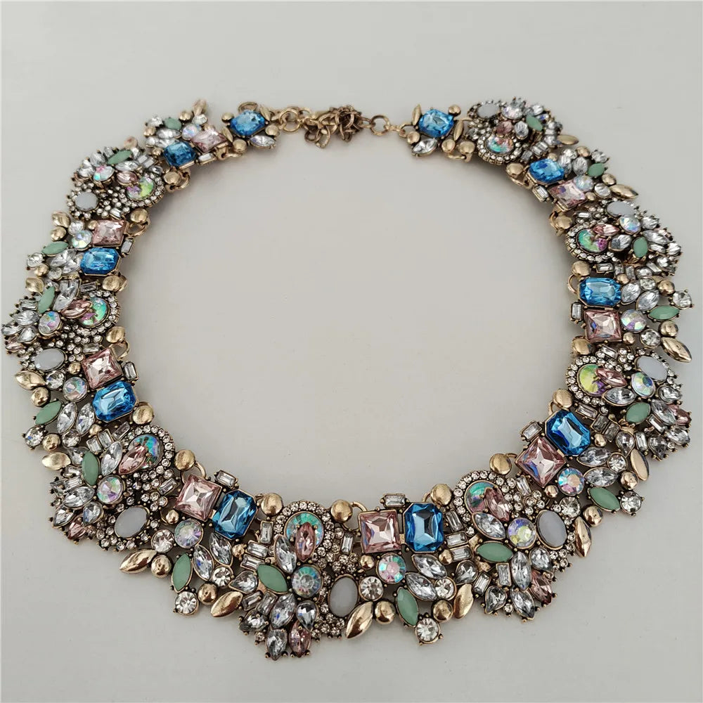 Elegant necklace with multicolored gemstones on a light gray background