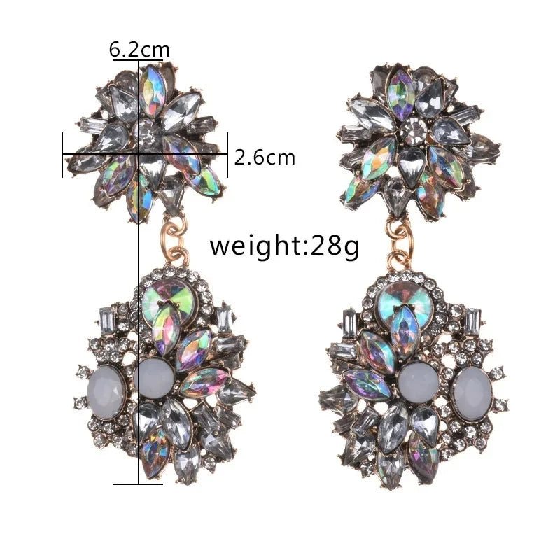 Pair of ornate earrings with measurements and weight displayed.