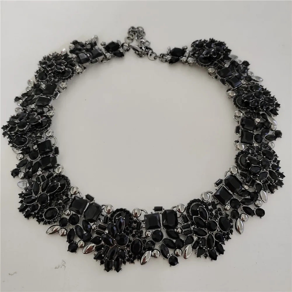 Black floral necklace on a white background